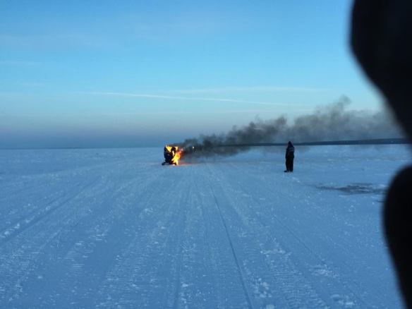 She hadn't gotten very far, when her snowmobile caught on fire!  She was able to get off and get away from it and wasn't injured in any way!  (Photo: Josh Carley)
